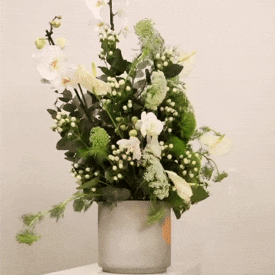 Elegant green and white flower arrangement in a decorative vase, featuring a mix of green flowers and white flowers, 110 CM height, 90 CM width.