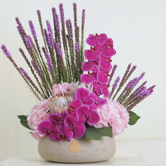 Violette luxury floral arrangement magenta cymbidium orchids blush lisianthus purple statice Kuwait Vitali Concept