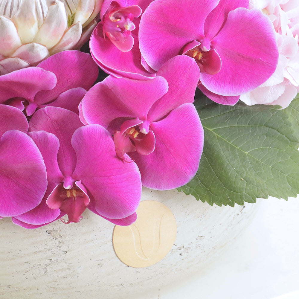 Violette luxury floral arrangement magenta cymbidium orchids blush lisianthus purple statice Kuwait Vitali Concept