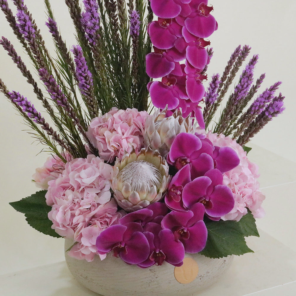 Violette luxury floral arrangement magenta cymbidium orchids blush lisianthus purple statice Kuwait Vitali Concept