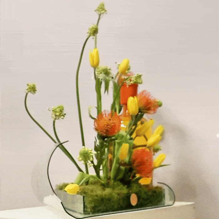 Luxurious floral arrangement with vibrant Tulips Pins, Ornithogalum, and a custom leaf tray for elegant home decor.