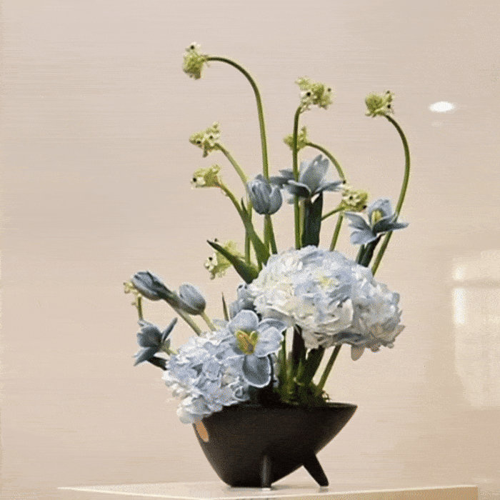 Ver III floral arrangement with hand-painted tulips, blue hydrangeas, and Ornithogalum in a sleek black vase, inspired by modern art.