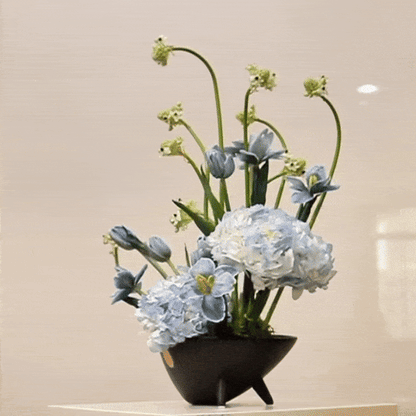 Ver III floral arrangement with hand-painted tulips, blue hydrangeas, and Ornithogalum in a sleek black vase, inspired by modern art.