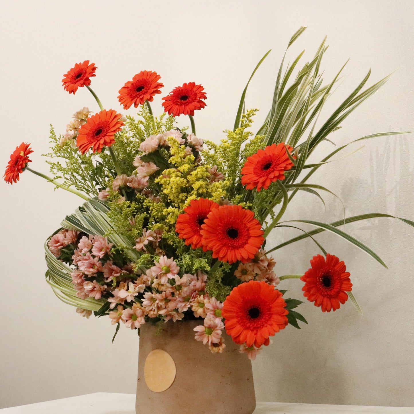 ORÉ luxury floral arrangement premium handcrafted golden toned blooms elegant statement gifting Kuwait Vitali Concept