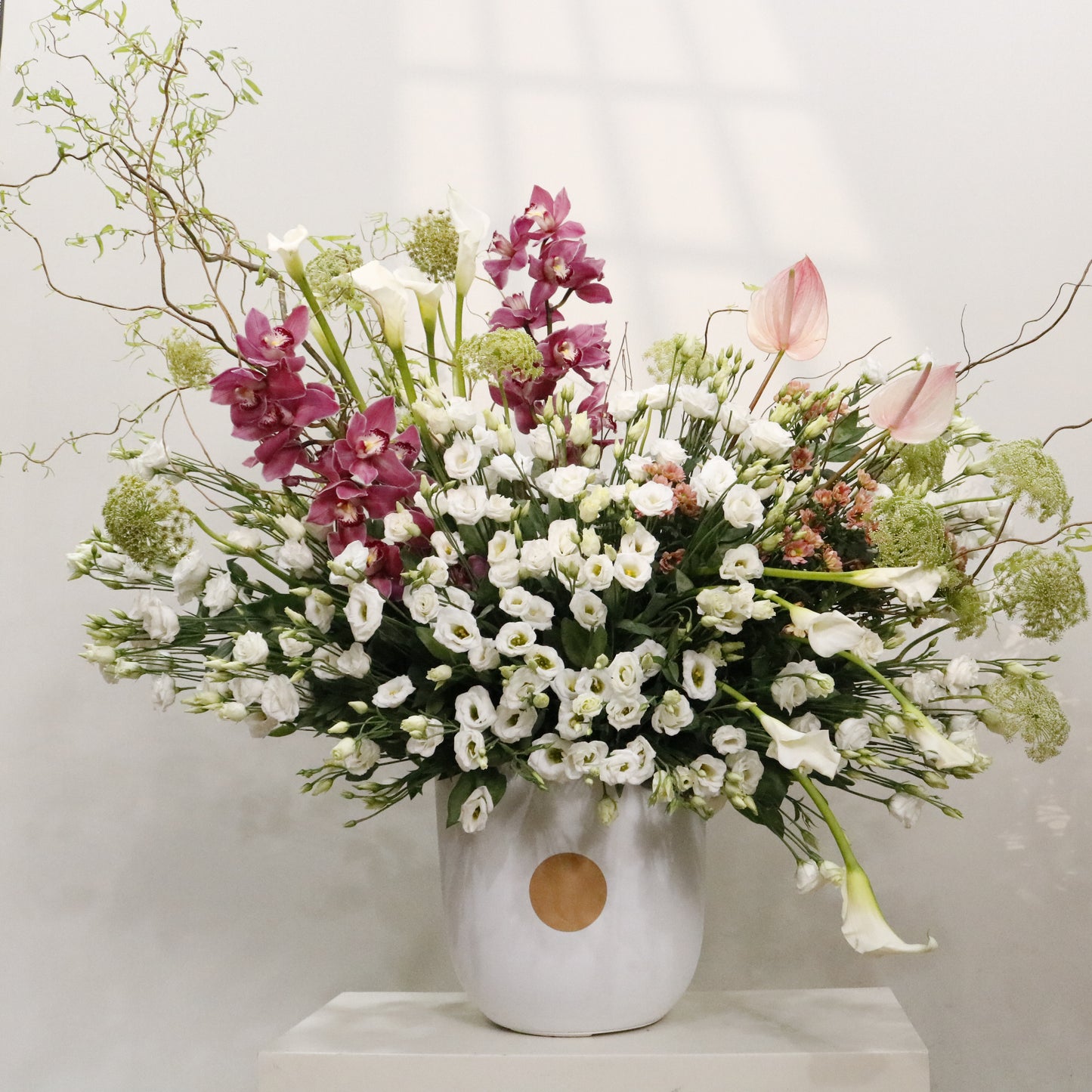 La Majesté luxury floral arrangement white lisianthus calla lilies cymbidium orchids blush anthuriums sculptural branches Kuwait Vitali Concept