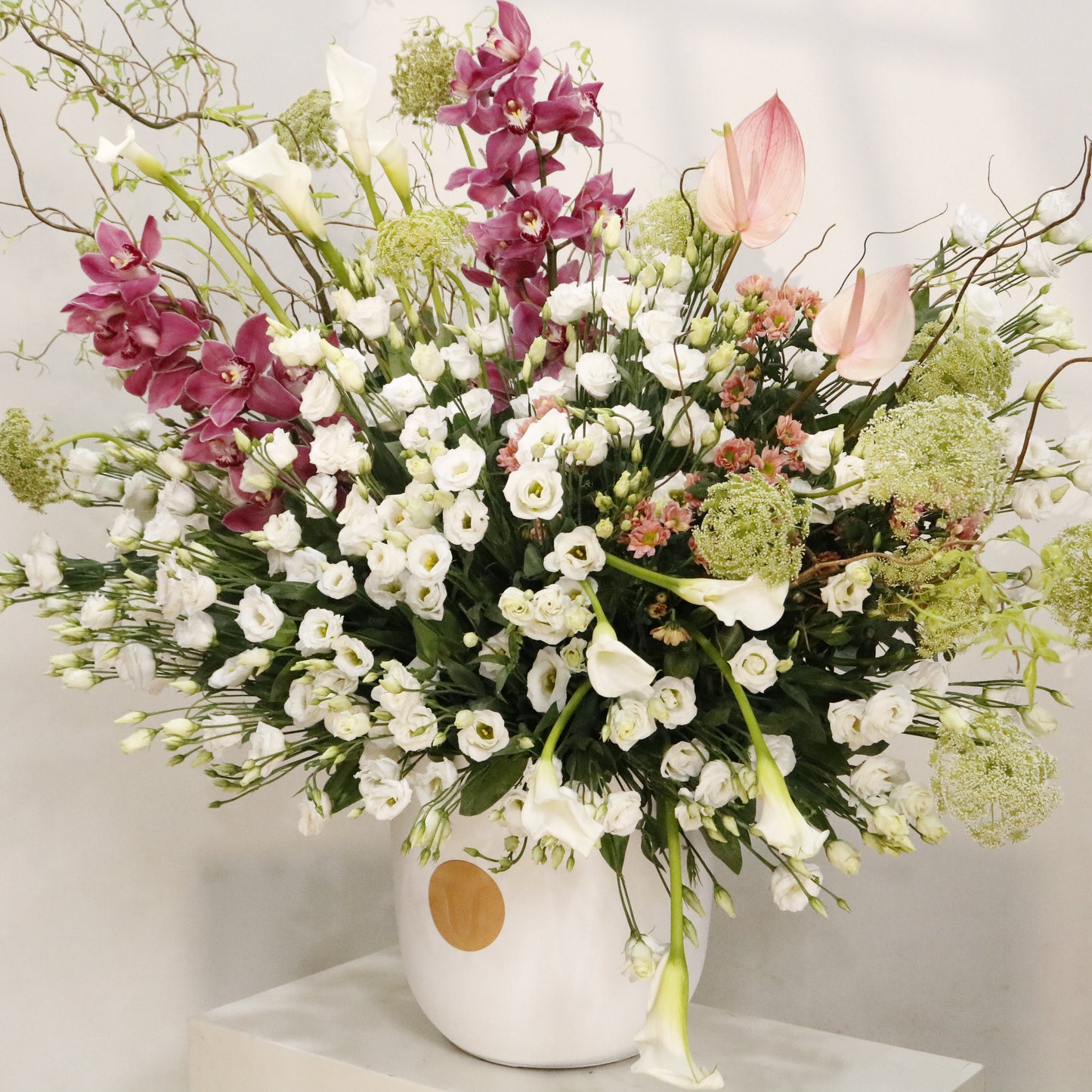 La Majesté luxury floral arrangement white lisianthus calla lilies cymbidium orchids blush anthuriums sculptural branches Kuwait Vitali Concept