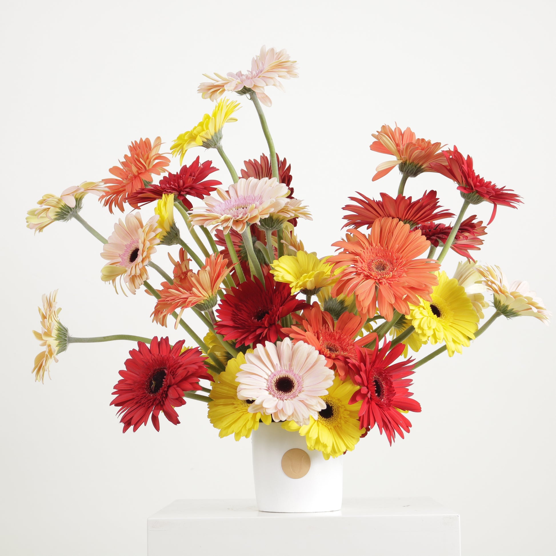 Fiesta de Color luxury floral arrangement vibrant red yellow pink gerberas ceramic vase Kuwait Vitali Concept