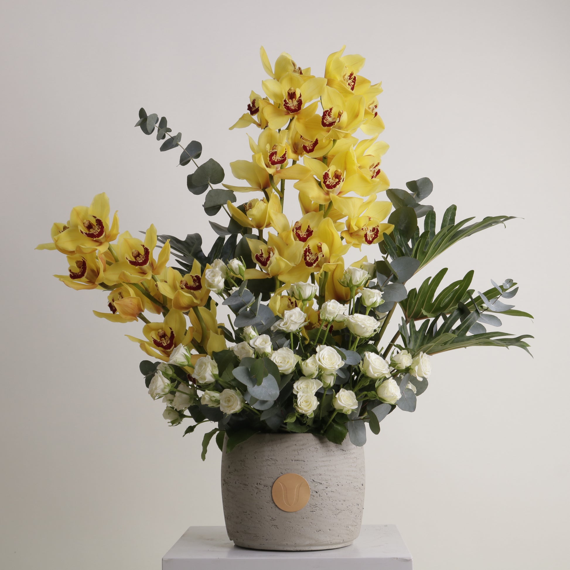 Royal Amber luxury floral arrangement yellow cymbidium orchids white roses luxury interiors Kuwait Vitali Concept