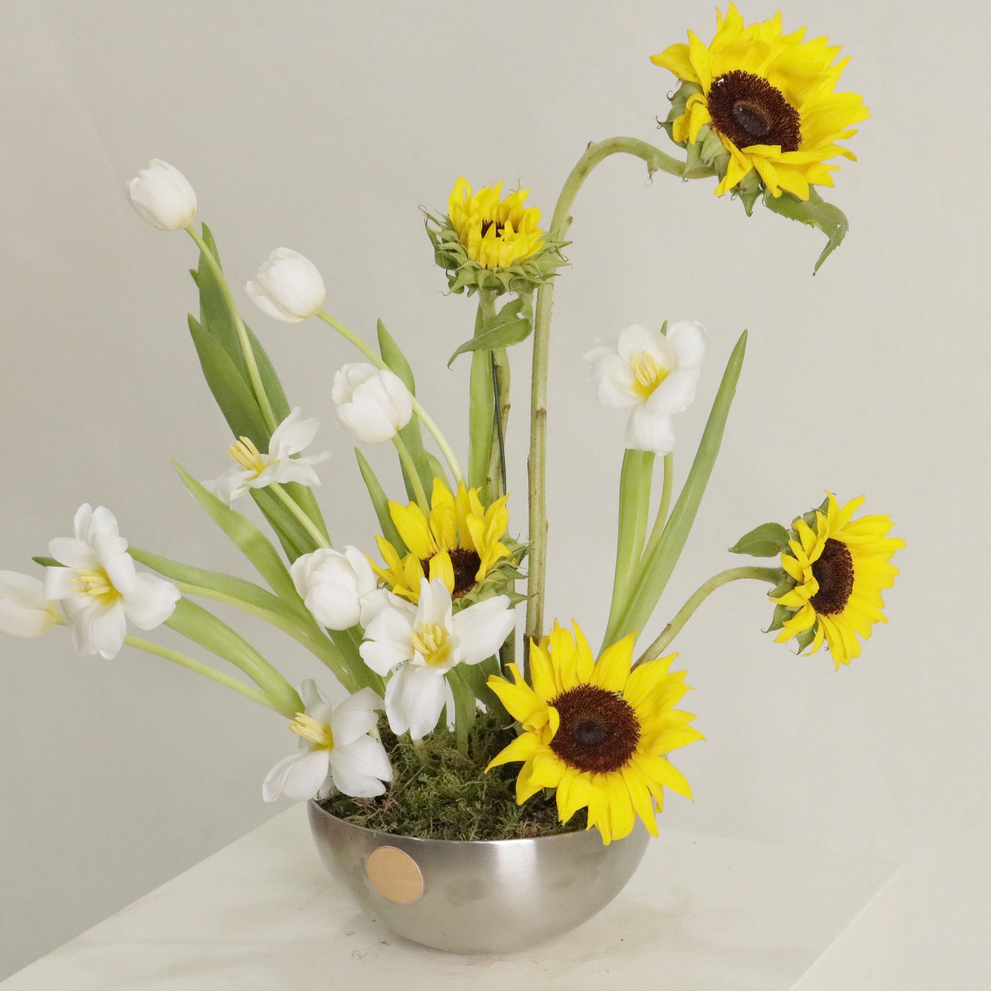 Sol luxury floral arrangement sculptural sunflowers white tulips silver bowl Kuwait Vitali Concept