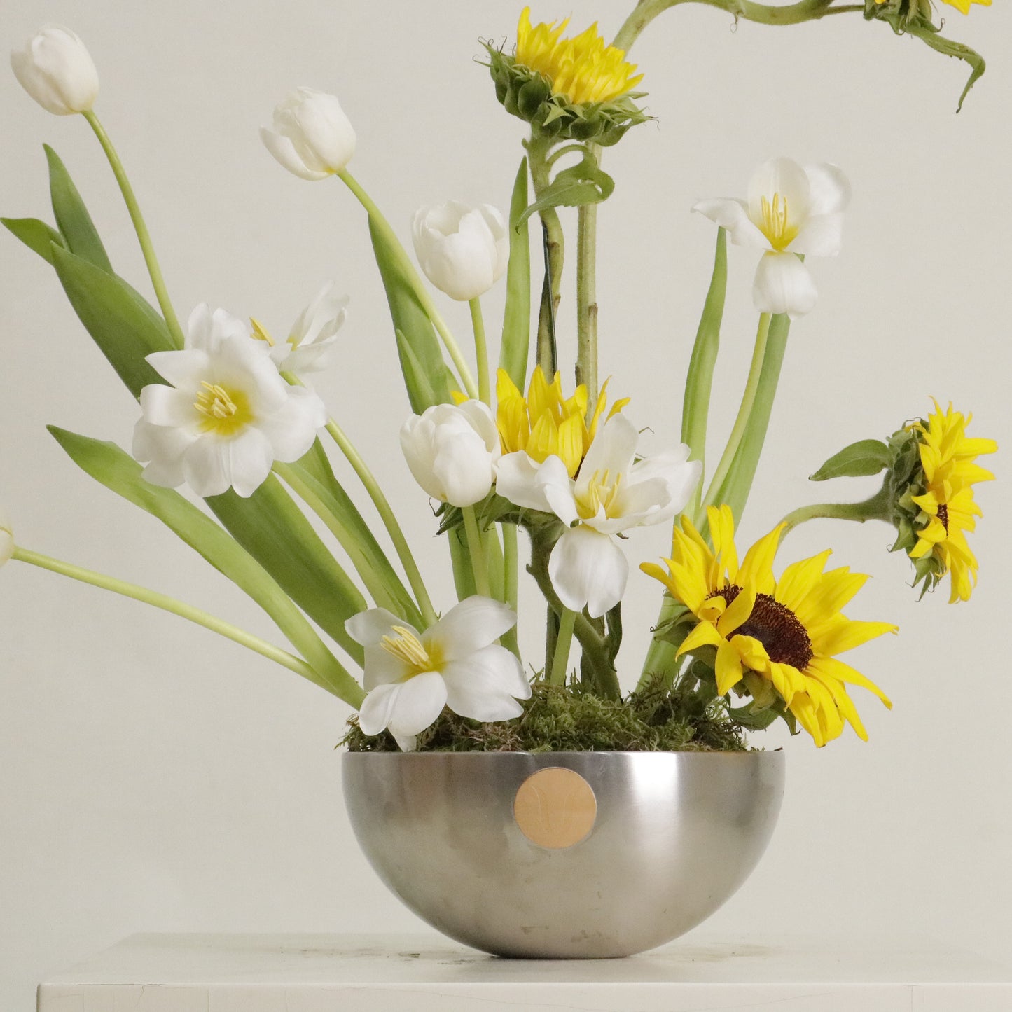 Sol luxury floral arrangement sculptural sunflowers white tulips silver bowl Kuwait Vitali Concept