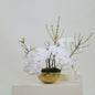 Heart Of Gold II arrangement featuring white orchids and forsythia, celebrating mothers with a gold heart design.