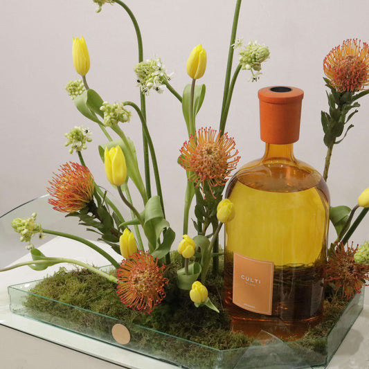 Exquisite Color Gift Aramara arrangement with Tulips Pins, Ornithogalum, and custom leaf tray, featuring a luxurious bottle centerpiece.