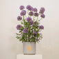 Tall floral arrangement with purple Alliums and delicate Clematis in a modern pot titled 'Love Purity', perfect for elegant interiors.