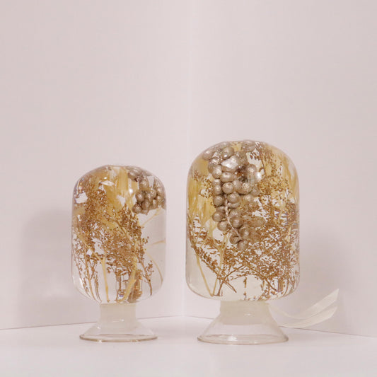Decorative glass domes with golden botanical elements by Style Jieum, inspired by forest tranquility and golden sunlight.