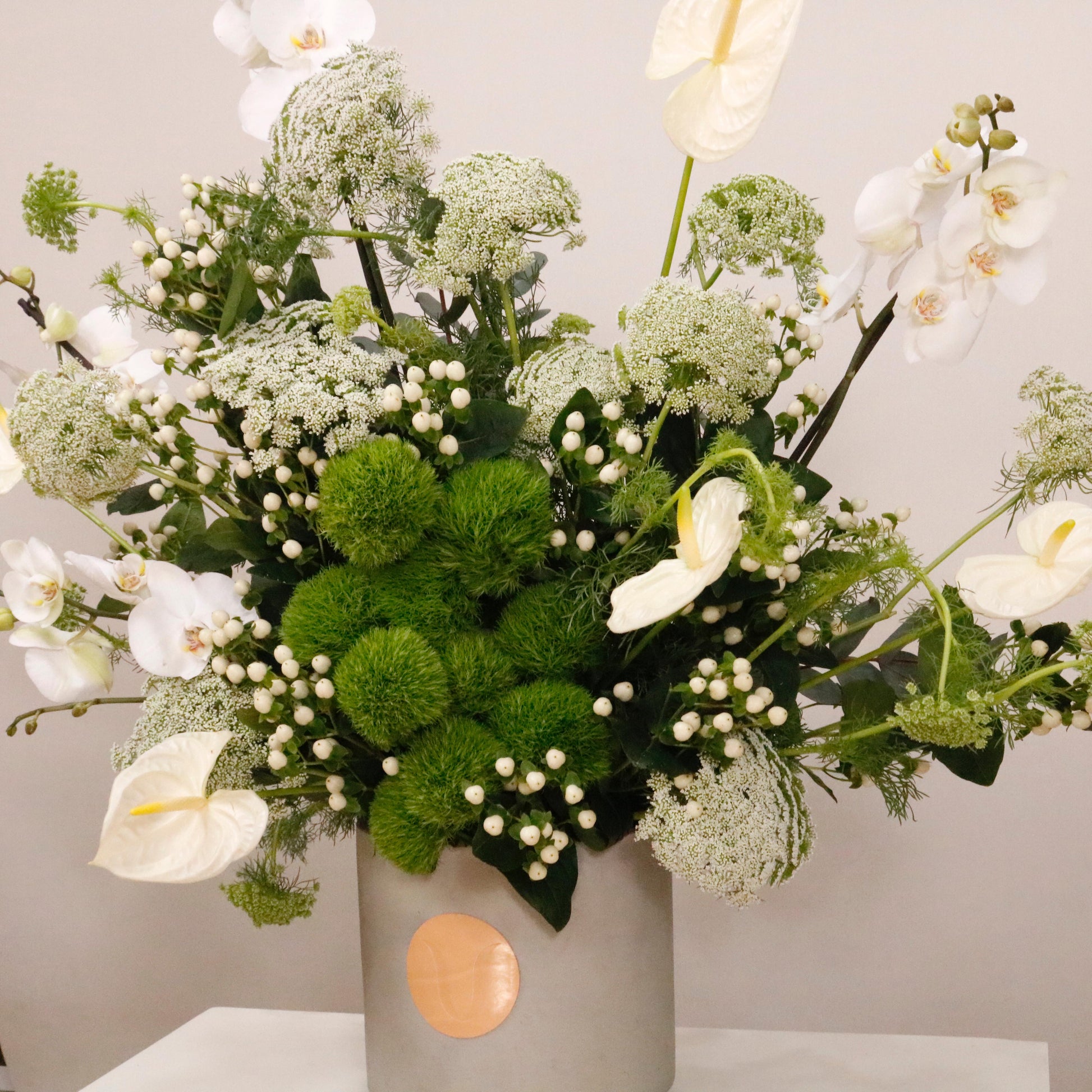 Elegant green and white flower arrangement in a decorative vase, featuring a mix of green flowers and white flowers, 110 CM height, 90 CM width.