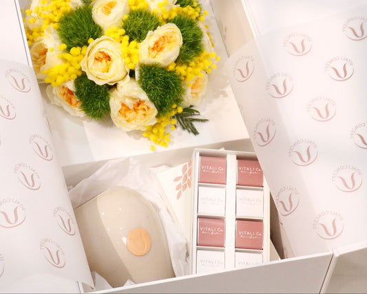 Bouquet of yellow flowers and chocolate  products in a box with a handmade vase 